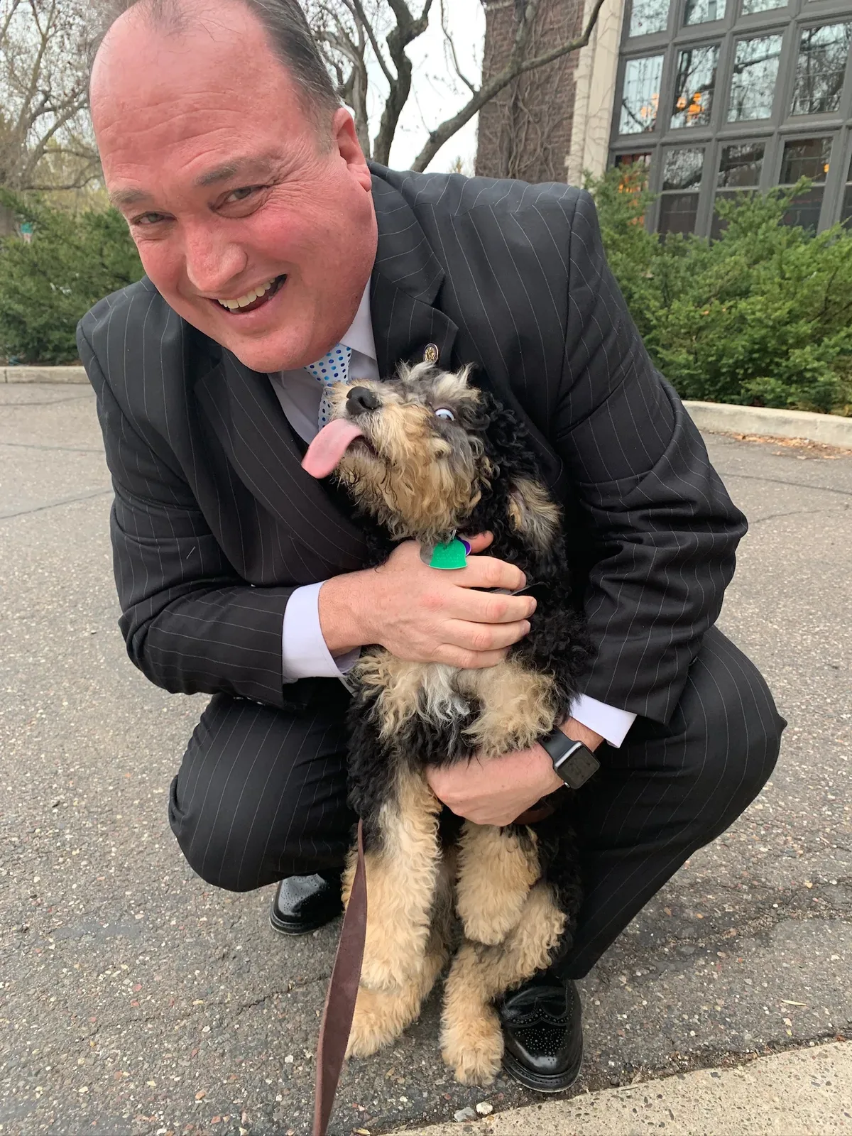 John Huot on a walk with his dog, Ginger, in a neighborhood setting