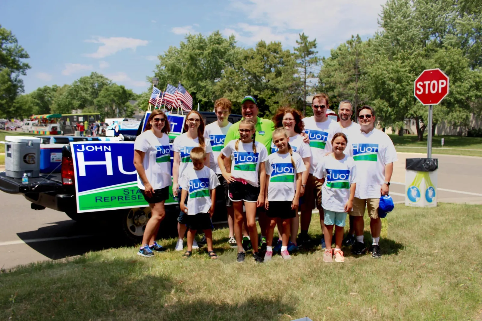 A group of District 56B parade volunteers holding Huot campaign signs
