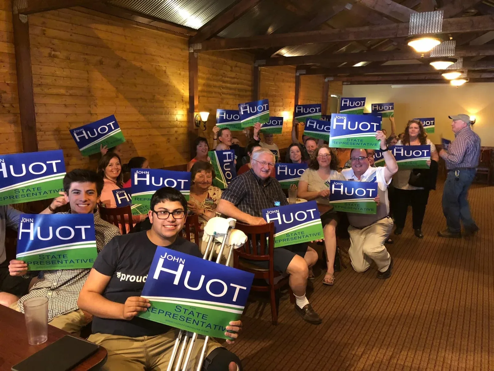 Campaign volunteers gathered at a phone-banking event, with John addressing the group